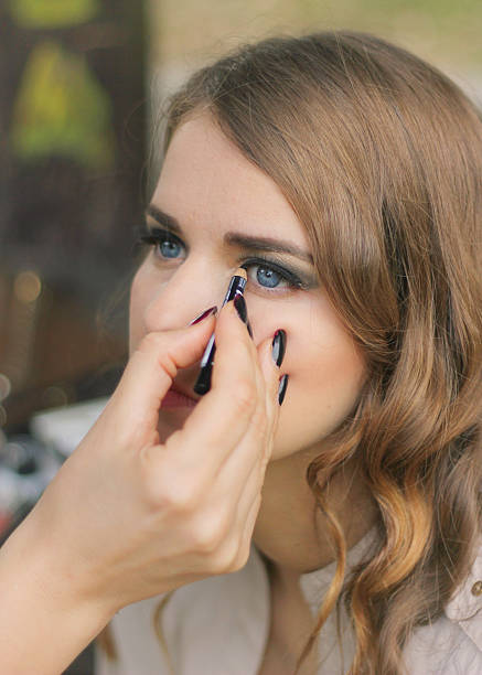 istock Beautiful girl applying makeup 522923461