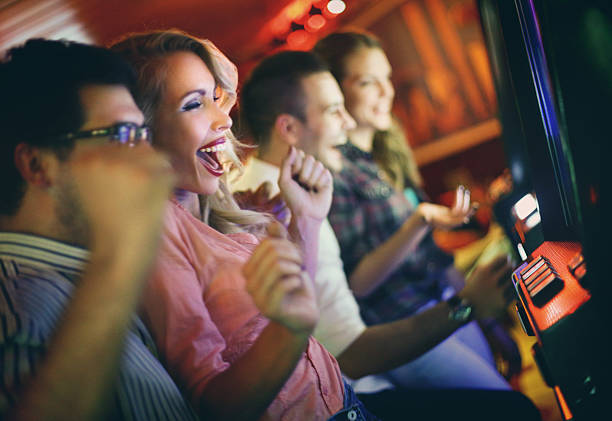istock Group of people playing slots in casino. 522923519