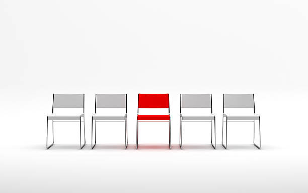 istock Group of four white chairs and one red 522926407