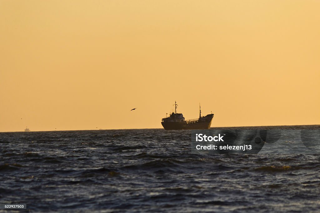 Ships in the sea The ships in the evening sea in beams of the setting sun Africa Stock Photo