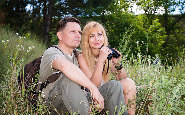 istock Hiking couple - hikers resting in valey. Relaxing after hike. 522944995