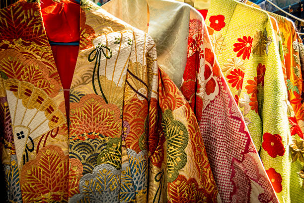 Traditional Japanese clothing Rack of colourful and elaborate traditional clothes in Tokyo kimono stock pictures, royalty-free photos & images