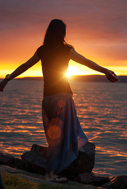 istock Woman enjoying the sunset at  lake 522948025