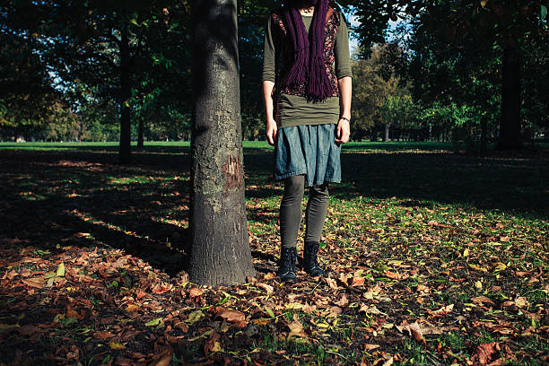 istock Young woman standing by a tree in autumn 522948127