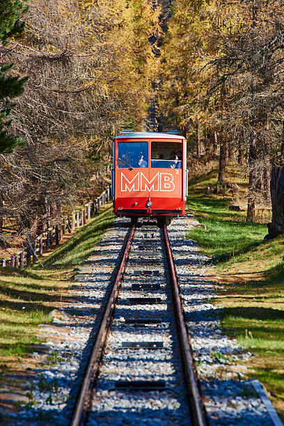 Muottas Funicular Samedan, Switzerland - October 26, 2014: a train on the Muottas Funicular arriving at Punt Muragl station. samedan stock pictures, royalty-free photos & images