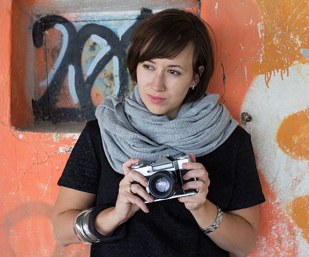 istock Girl holding a retro camera 522949241