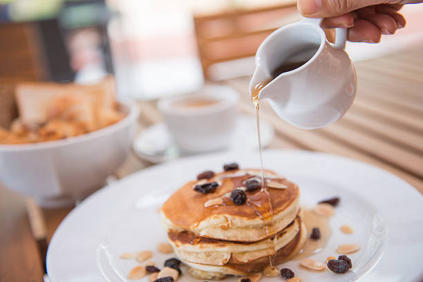istock pouring pure honey into pancake 522949245