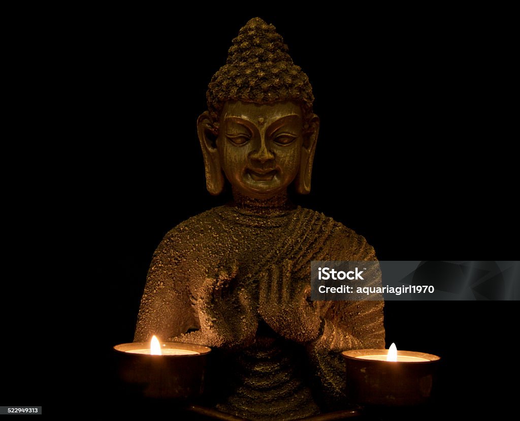 Peace of mind budha with two candles on a black background Asia Stock Photo