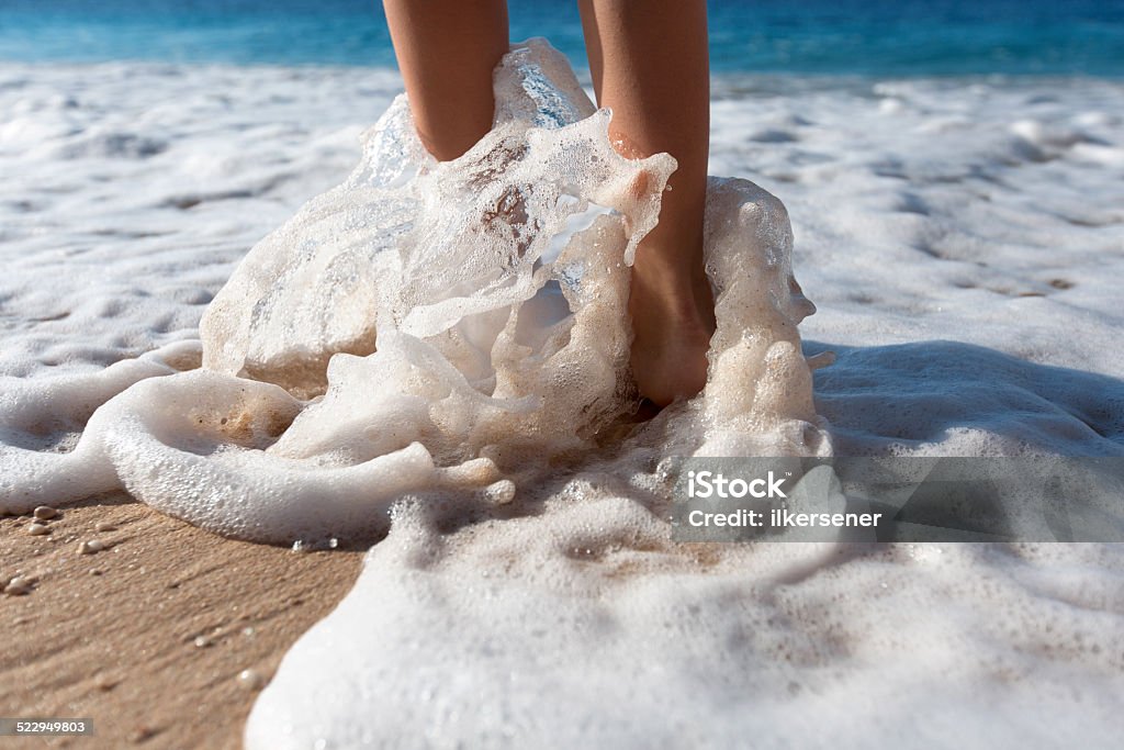 Woman walking on the sea Woman walking on the sea with waves. Barefoot Stock Photo