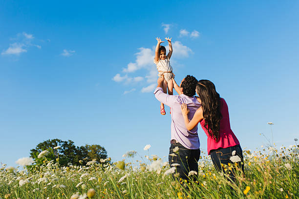 istock Little girl playing with parents 522950345