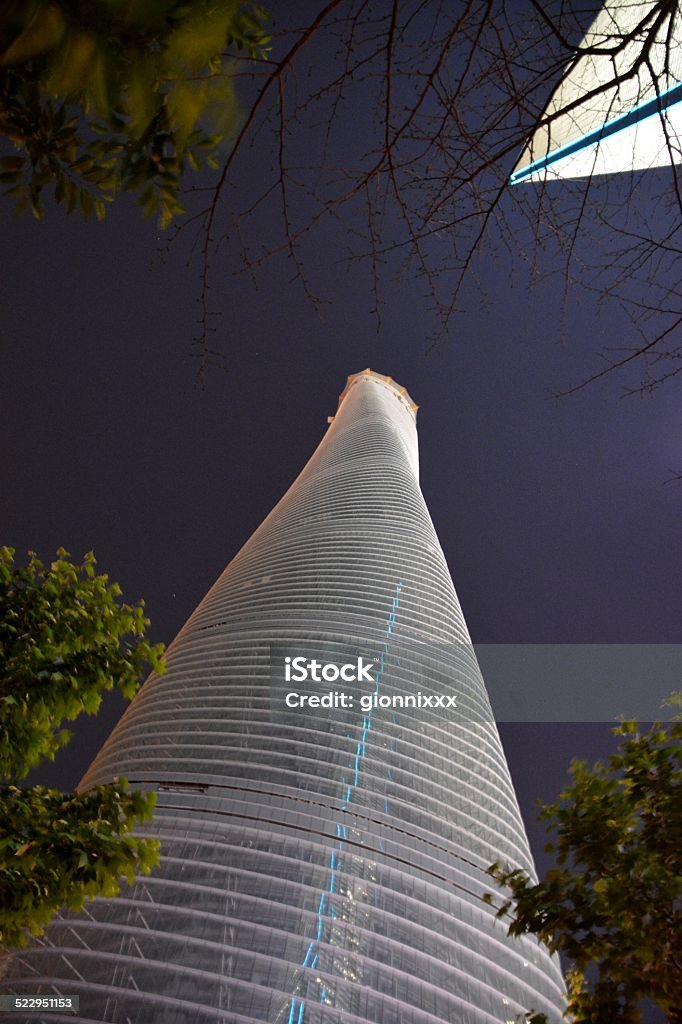 Shanghai Tower Skyscraper by night Night view of the Shanghai Tower, a supertall skyscraper under construction in Lujiazui, Pudong, The building stands 632 metres high and will be the tallest structure in china and the second tallest building in the world. Architectural Feature Stock Photo