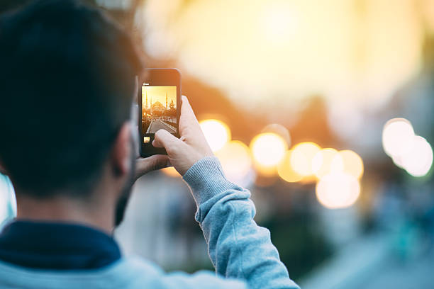 Tourist taking a photo of Sultan Ahmed Tourist photographing  Sultan Ahmed mosque - copyspace muslim photographer stock pictures, royalty-free photos & images