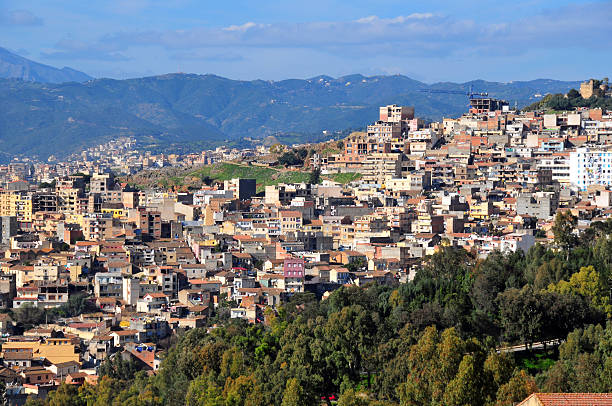 Béjaïa, Kabylia, Algeria: dense urban development of a slope Béjaïa / Bougie, Kabylia, Algeria: anarchic urban planning - building covering the valley and the hill sides - mountains in the background kabylie stock pictures, royalty-free photos & images