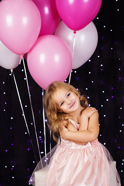 istock Little girl with pink balloons 522952521