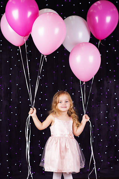 istock Little girl with pink balloons 522958839