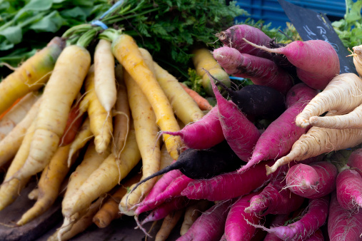 Daikon radish on the market, red, yellow, white and black