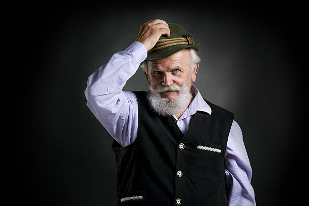 istock Old bavarian man in hat on black background 522960843
