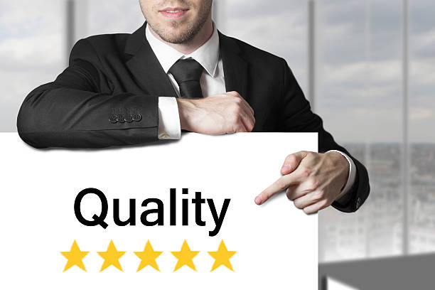 istock businessman pointing on sign quality 522963667