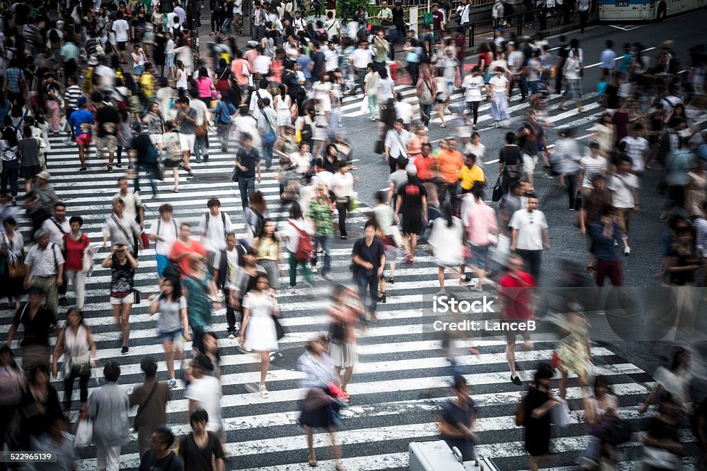 Tokyo crowd Motion blur on large crowd at the famous Shibuya Crossing in the Japanese capital Road Intersection Stock Photo