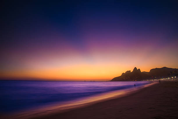 Sunset at Ipanema, Rio de Janeiro, Brazil Night falling on Ipanema, Rio de Janeiro, Brazil two brothers mountain stock pictures, royalty-free photos & images