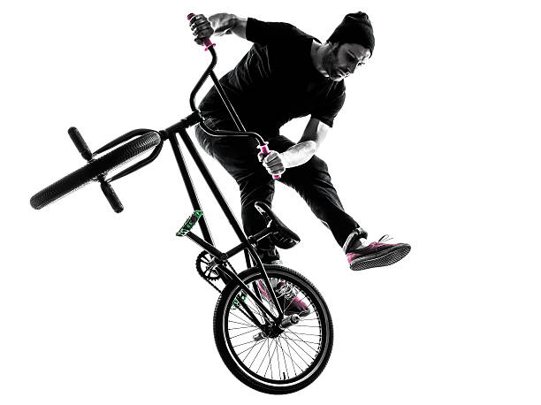 man bmx acrobatic figure silhouette one man exercising bmx acrobatic figure in silhouette studio isolated on white background bicycle stunts stock pictures, royalty-free photos & images