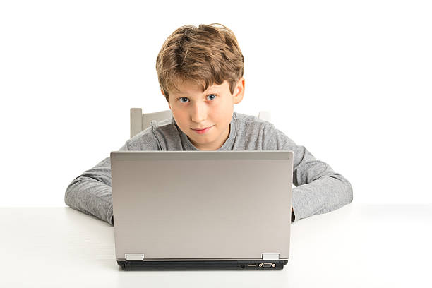 istock one 10 years old boy in front of laptop 523003631