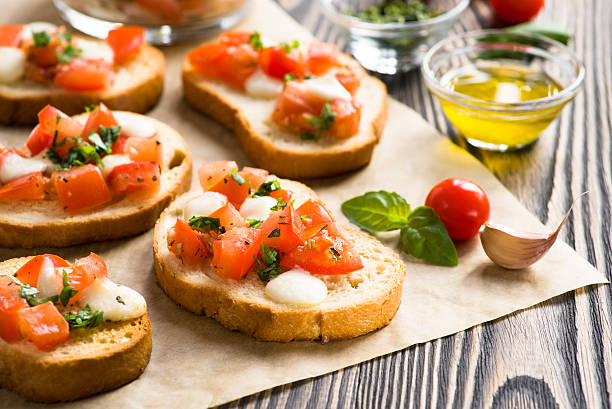 istock Bruschetta with roasted tomatoes, mozzarella cheese, garlic and 523004191