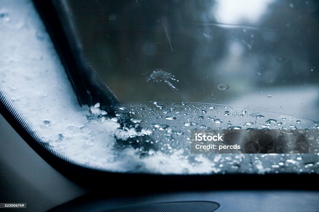 Hail on windshield Close up of hail on windshield, country road in the background. Car Stock Photo