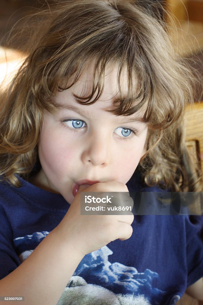 Adorable boy Photo of the beautiful blue-eyed boy pensively sucking his thumb Child Stock Photo