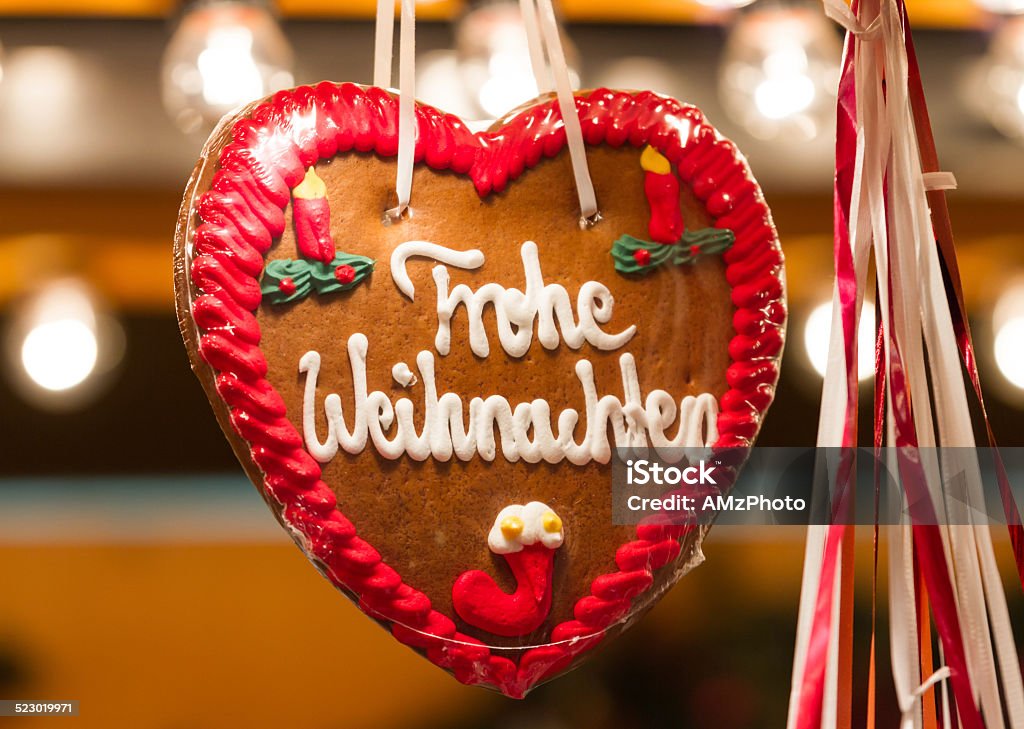 Merry Christmas Closeup of a traditional gingerbread heart at a Christmas Market, with the words "Merry Christmas" in German language Gingerbread Cake Stock Photo