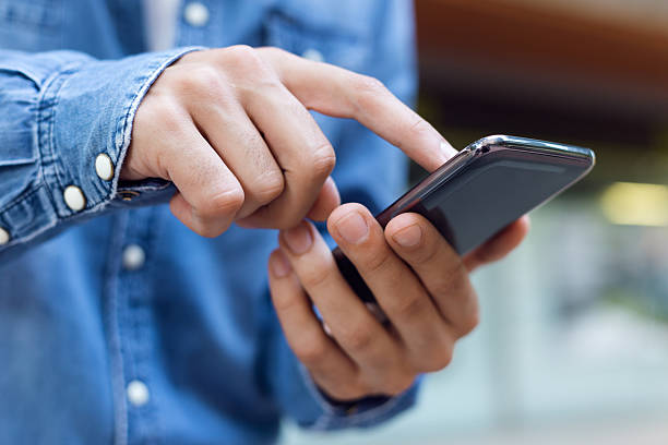 istock Modern young man with mobile phone in the street. 523020837