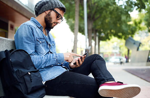 istock Modern young man with mobile phone in the street. 523020865
