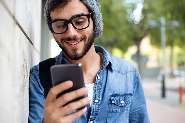 istock Modern young man with mobile phone in the street. 523020877