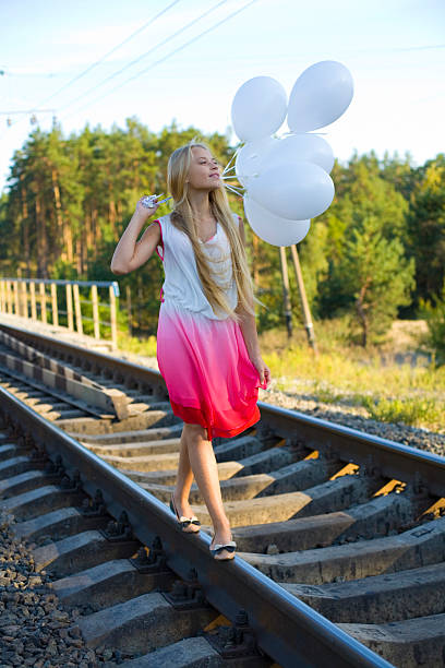 istock Beautiful girl with white balloons 523021193