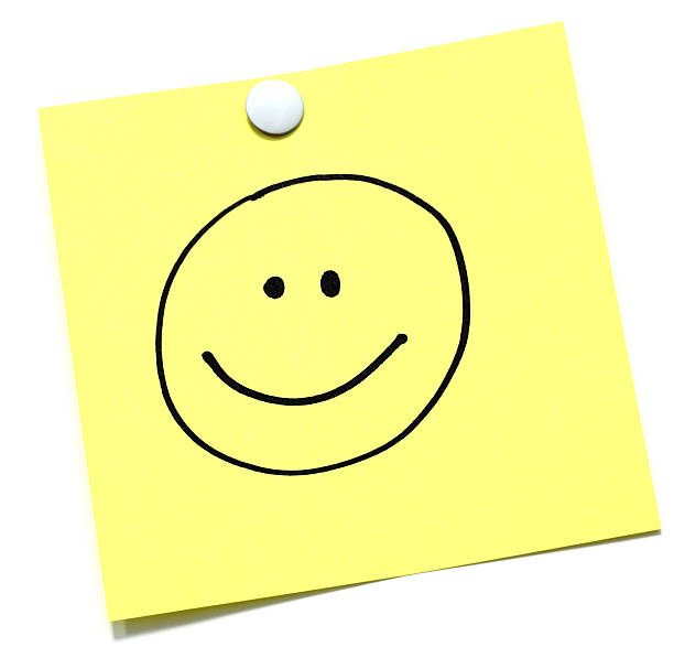 Smiley Face 
Smile on a yellow sheet. smiley face postit stock pictures, royalty-free photos & images