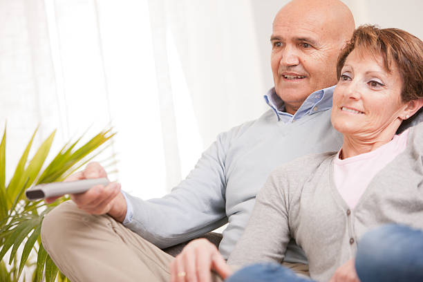 istock mature couple watching tv on the sofa 523031457
