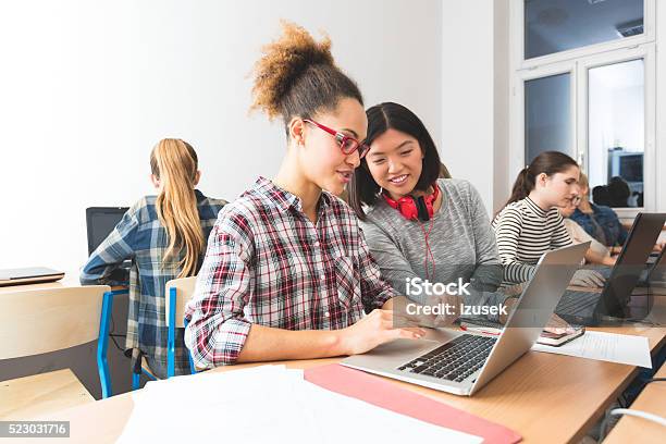 Multi Ethnic Students Learning Computer Programming Working Together Stock Photo - Download Image Now