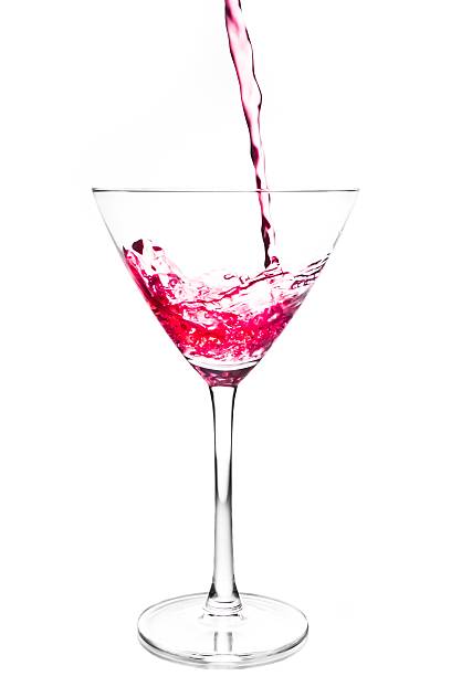 istock filling a glass with red cocktail and splashing 523032020
