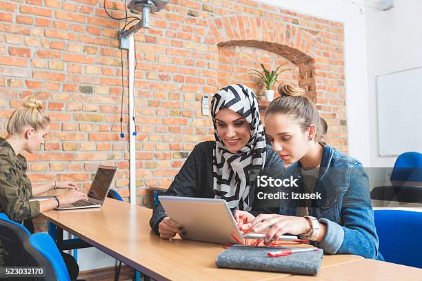 Musilm Young Woman Working On Laptop With Friend Stock Photo - Download Image Now - Achievement, Adult, Asian and Indian Ethnicities