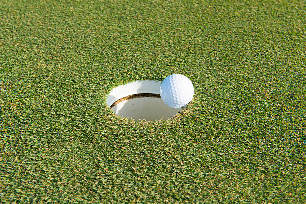 istock golf hole on a field and golf ball 523032288