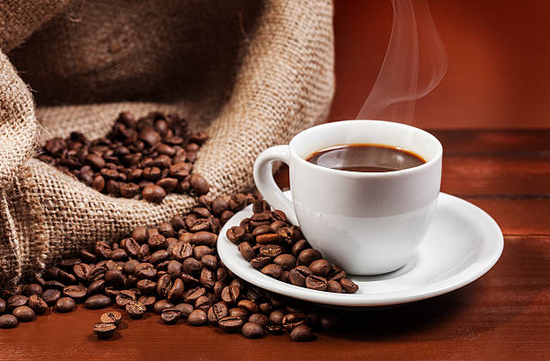 istock Coffee cup and jute sack full of coffee beans 2 523034713