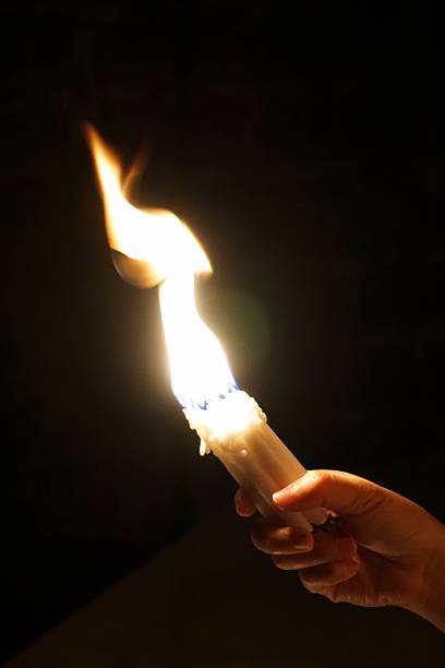 istock hand carry candle in flame 3 523035087