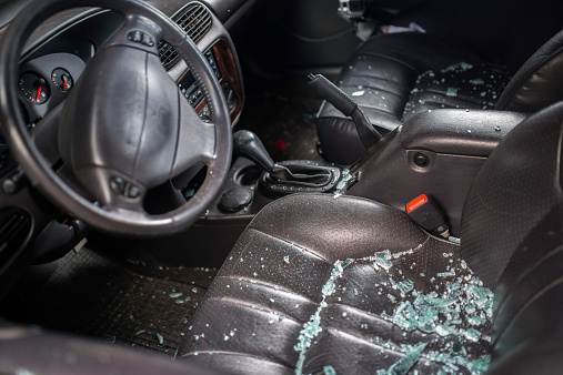 Shattered glass inside of a car after a car thief broke into the vehicle 