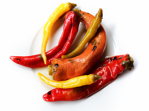 
Hot red and yellow chili or chilli pepper isolated on white background.