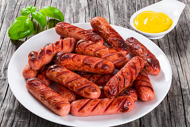 istock Grilled sausages on a white dish, close-up 523035632