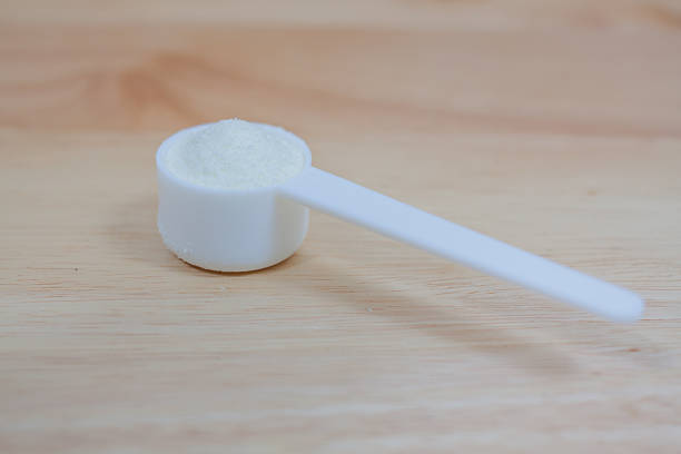 istock Collagen protein powder in a measuring spoon. 523036980