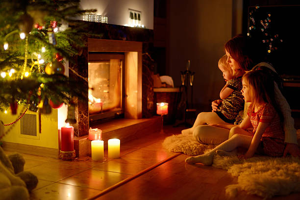 istock Happy family by a fireplace on Christmas 523036987