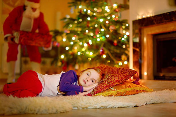 istock Little girl sleeping under the Christmas tree 523037105