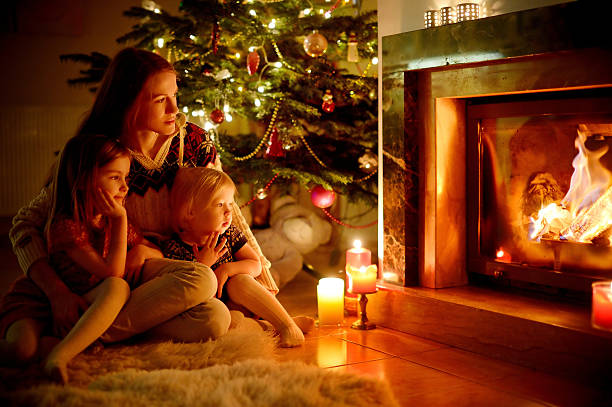 istock Happy family by a fireplace on Christmas 523037143