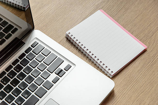 istock Wood office table with laptop and notebook. Top view 523040702